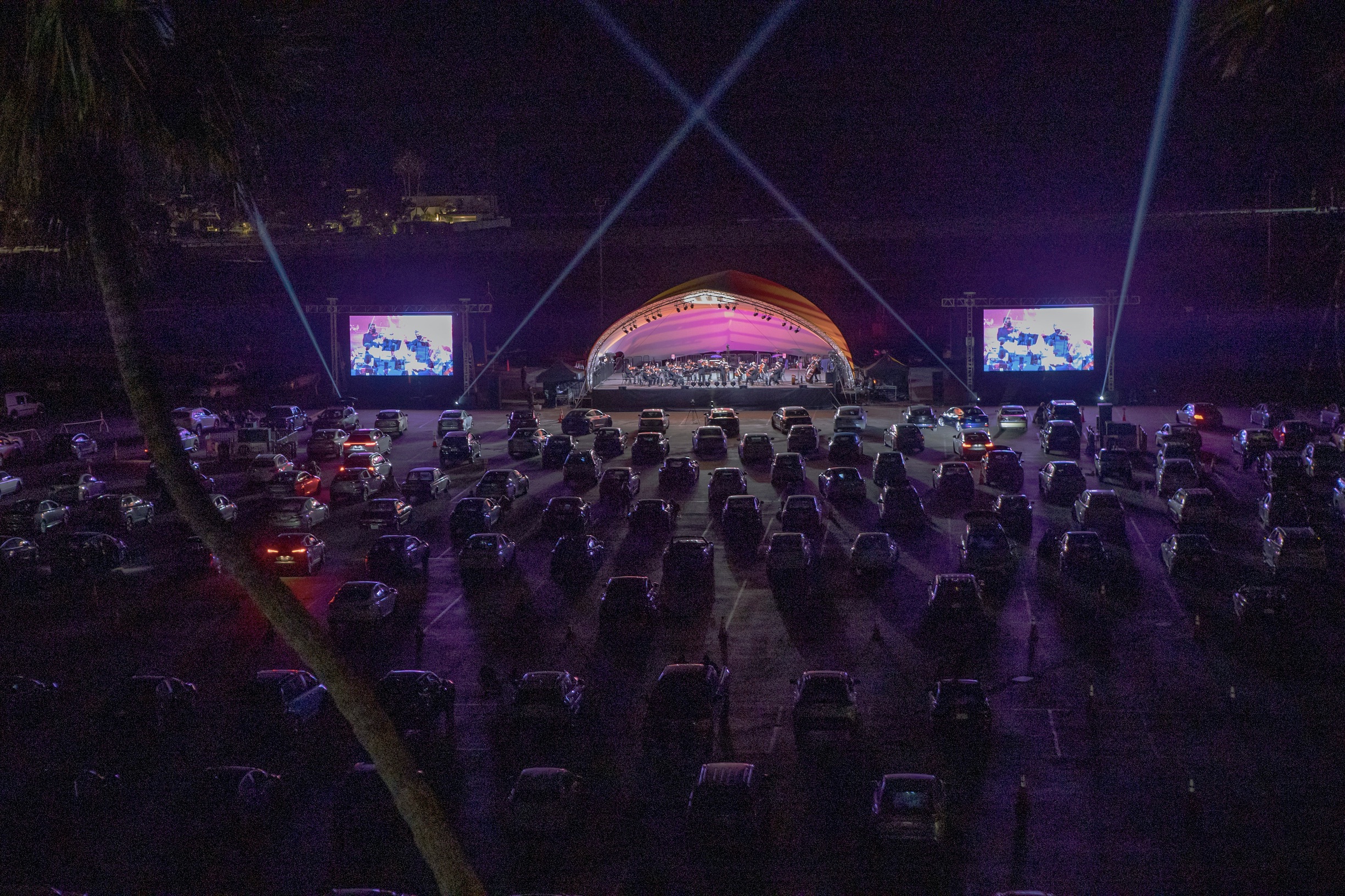 Parking lot of cars watching Mainly Mozart performance
